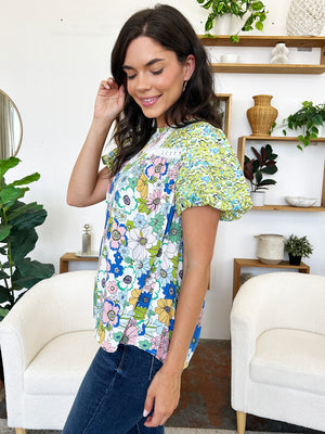 Floral patchwork blouse with puff sleeves and white lace trim, in lime and cerise colors.