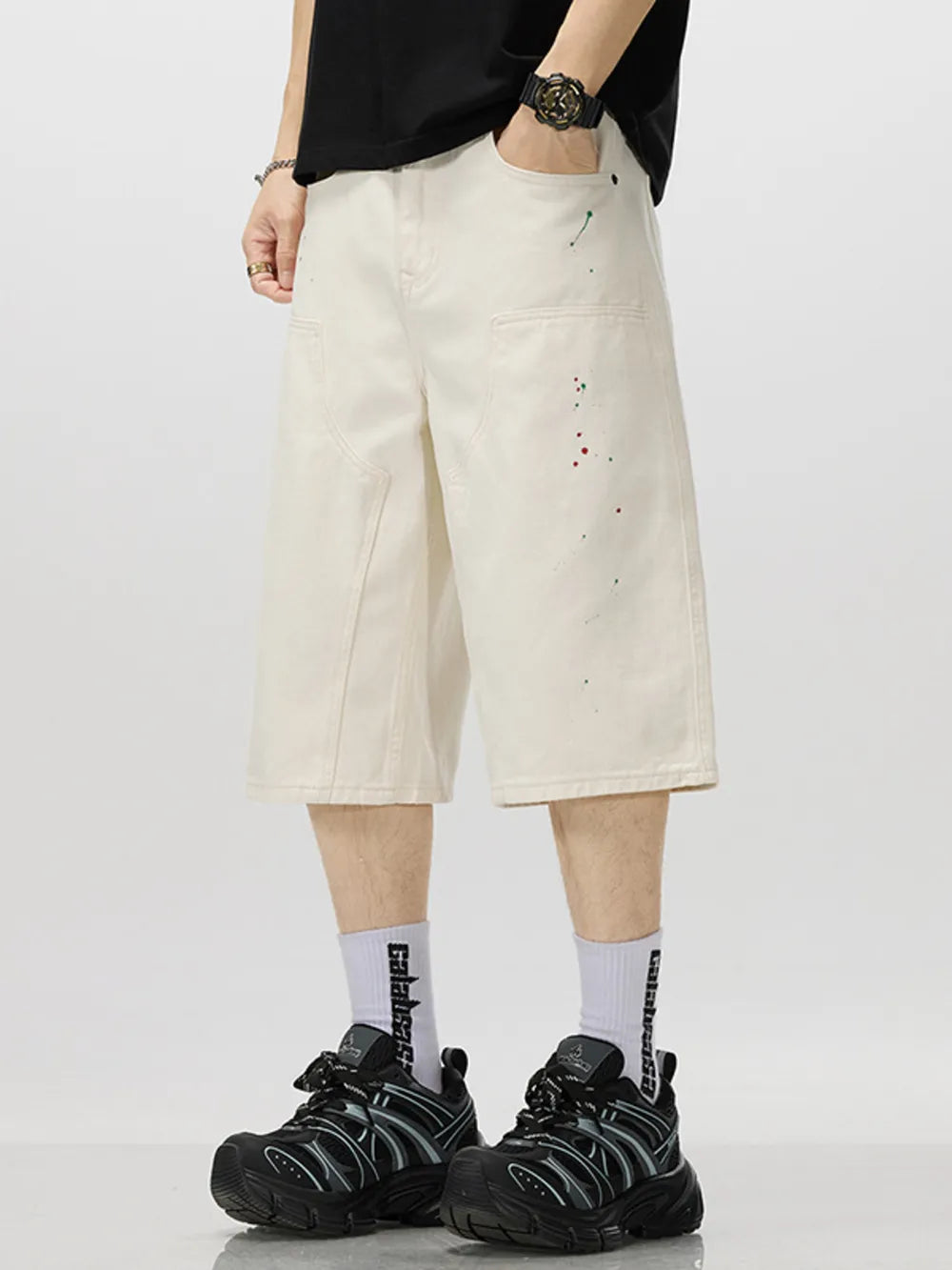 Cream cotton denim capris for him with artistic paint splatter detail.