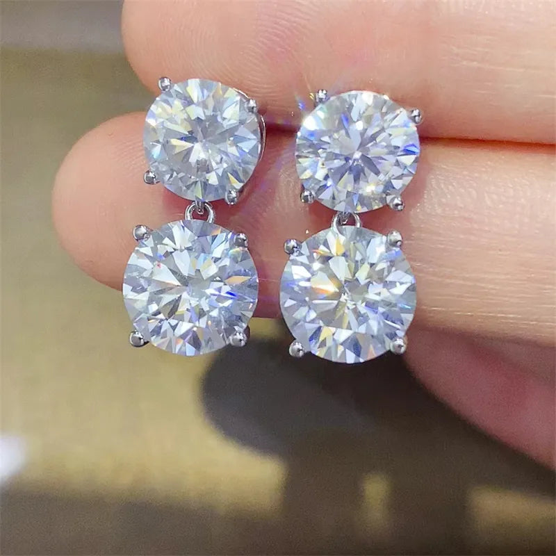 Silver double-drop stud earrings with round cubic zirconia stones.