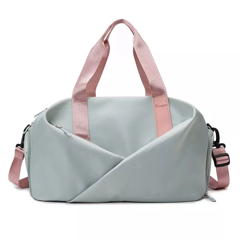 Pastel blue nylon travel bag with pink straps and adjustable shoulder strap.
