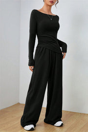 Black boat neck loungewear set with long sleeves and wide-leg pants.