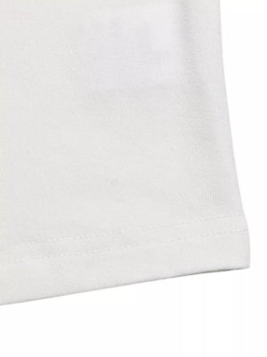 White t-shirt with cap sleeves and a delicate lace trim detail.