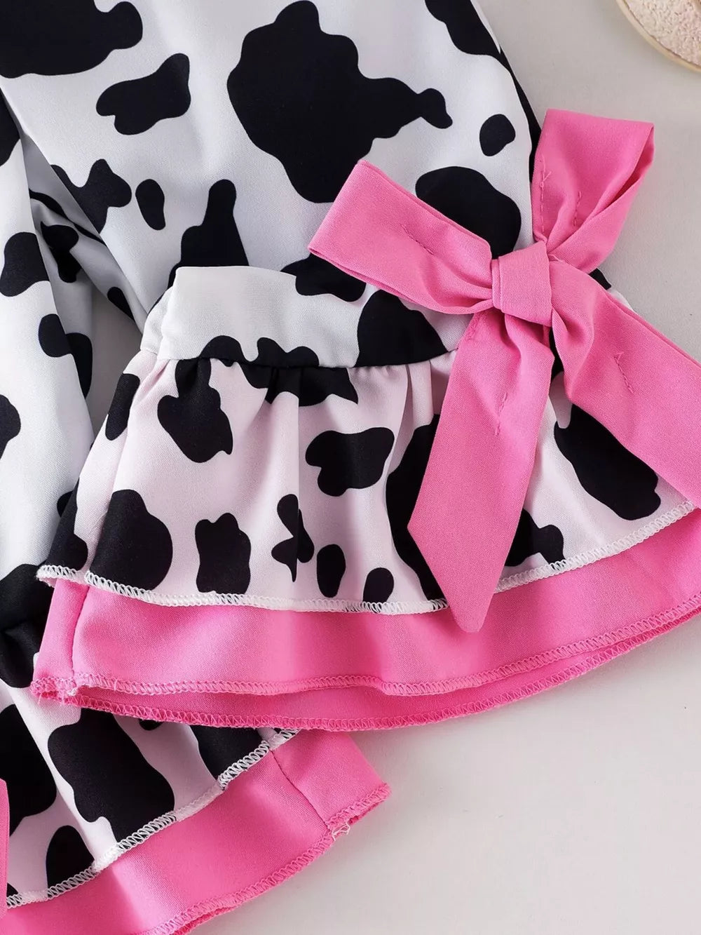 Children's Cow Print Ruffle Jumpsuit in Brown And White, back view