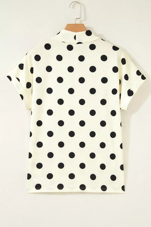 Cream polyester t-shirt with black polka dots, high neck, and short rolled sleeves.