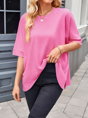 Pink relaxed fit t-shirt with drape sleeves and crew neck, styled with black pants.