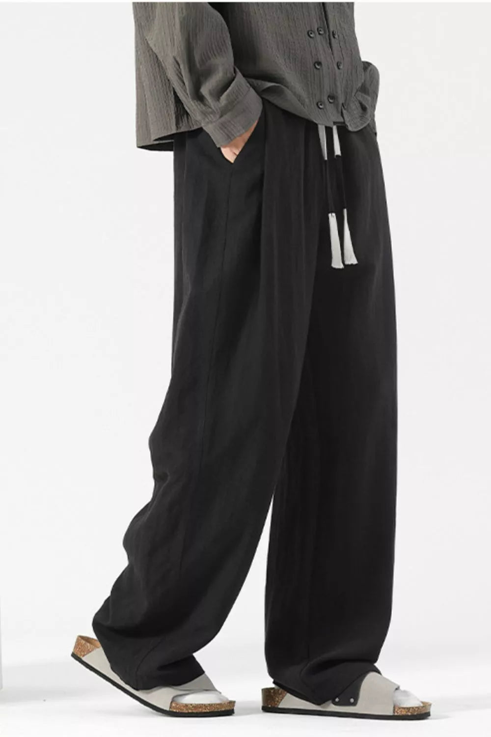 Black wide-leg lounge sweatpants with drawstring and pockets.