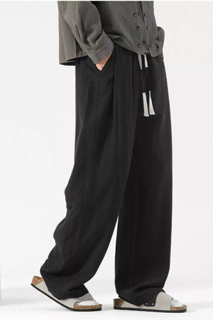 Black wide-leg lounge sweatpants with drawstring and pockets.