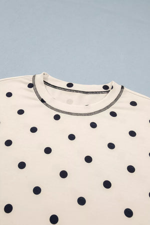 White polyester bikini top with navy polka dots and contrast stitching.