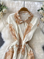 White collared button-down romper with brown paisley print and elastic waist