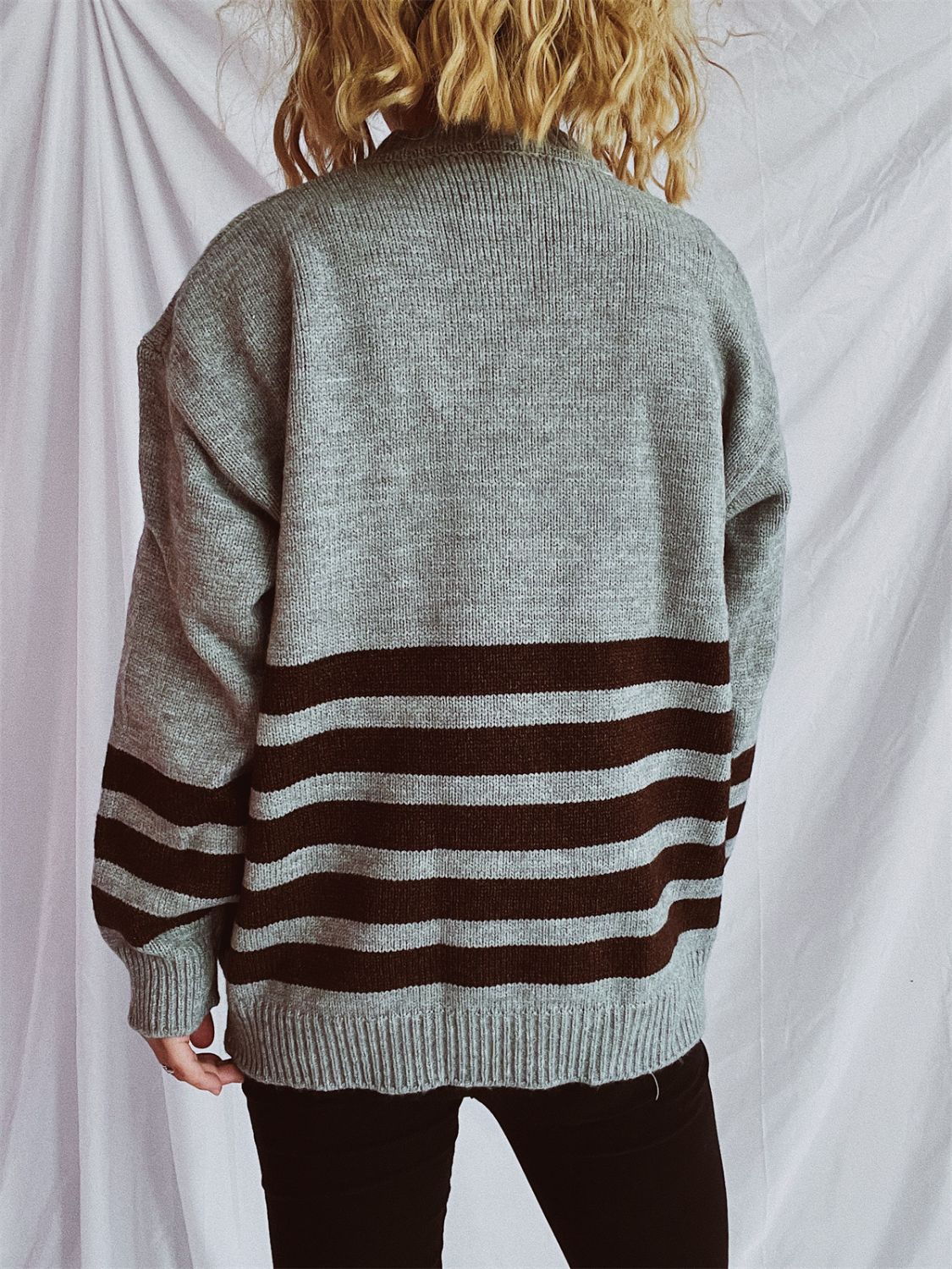 Horizontal stripe ribbed knit sweater in dark gray with brown stripes, crew neck, long sleeves.