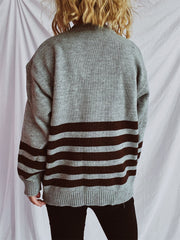 Horizontal stripe ribbed knit sweater in dark gray with brown stripes, crew neck, long sleeves.