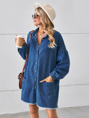 Dark blue denim shirtdress with voluminous sleeves, button front, pockets, and frayed hem.