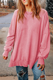 Oversized washed cotton sweatshirt in carnation pink with side slits and crew neck.