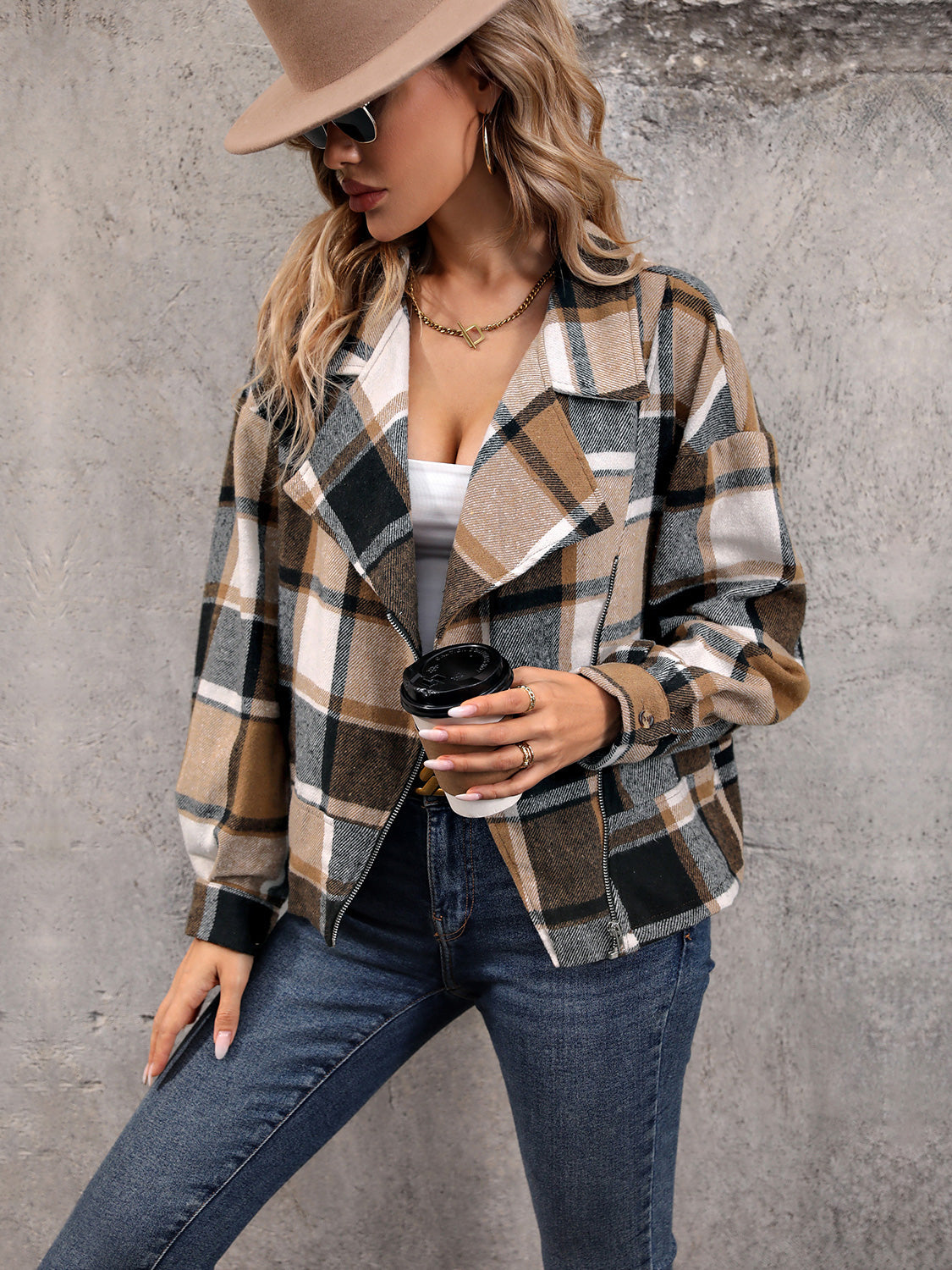 Checked plaid cropped moto jacket in camel with a wide collar and zipper closure.