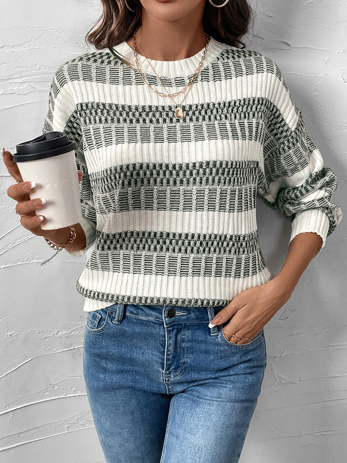 Chic contrast knit pullover sweater in white with black geometric pattern, crew neck, long sleeves.