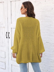 Chartreuse balloon sleeve open knit cardigan with ribbed texture.