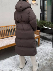 Dark brown puffer trench coat with hood and tie-belt, long sleeves, full length.
