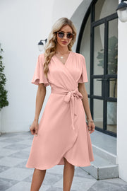 Silk wrap midi dress in watermelon pink with butterfly sleeves and adjustable tie waist.