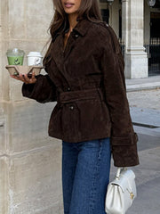 Brown suede trench coat with lapel collar, tie waist, and cropped length.