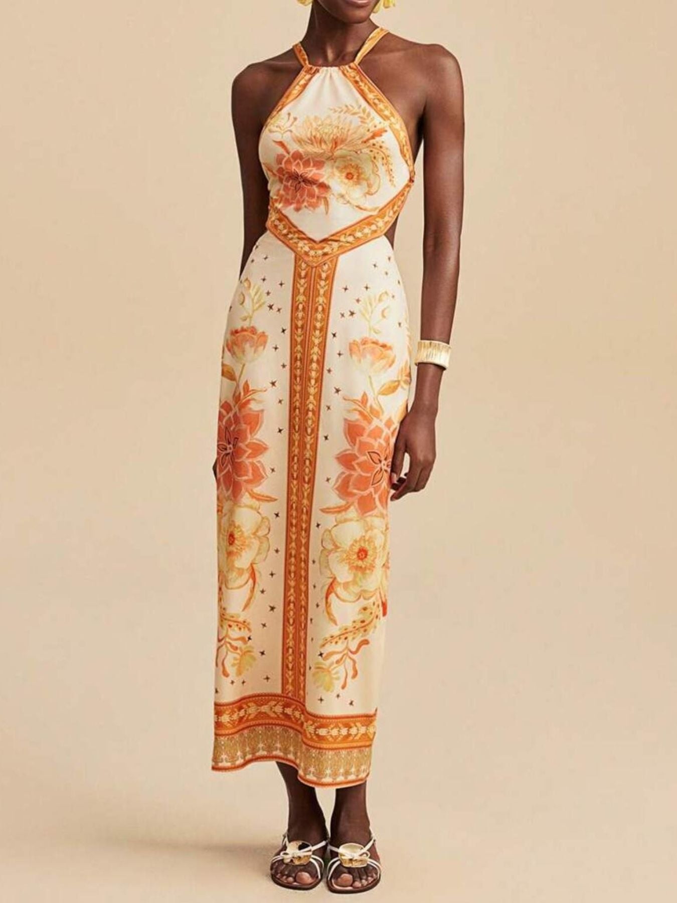 Floral print backless maxi dress with halter neck and orange floral details.