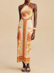 Floral print backless maxi dress with halter neck and orange floral details.