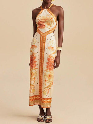 Floral print backless maxi dress with halter neck and orange floral details.
