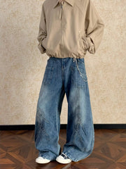Men's blue washed wide-leg jeans with chain detail and paneling