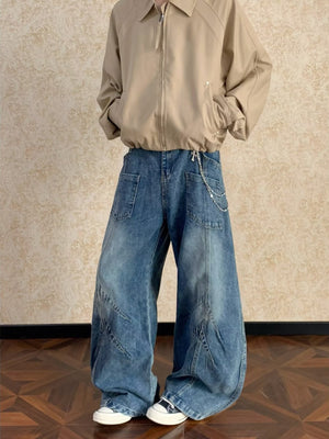 Men's blue washed wide-leg jeans with chain detail and paneling