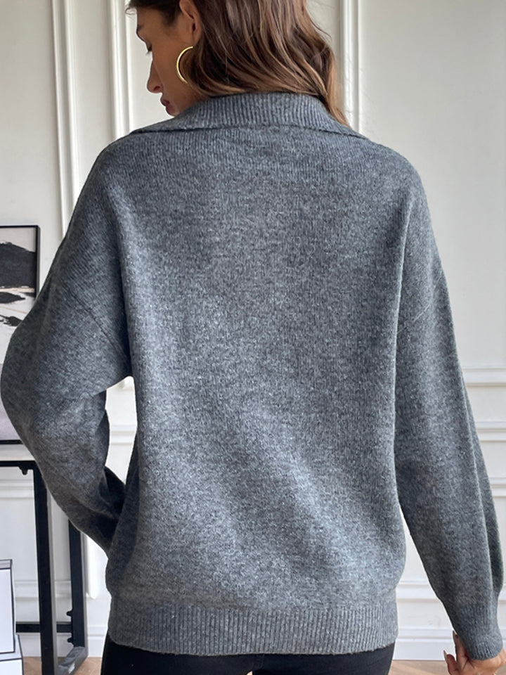 Charcoal acrylic knit sweater with a contrast collar and zip-up detail.