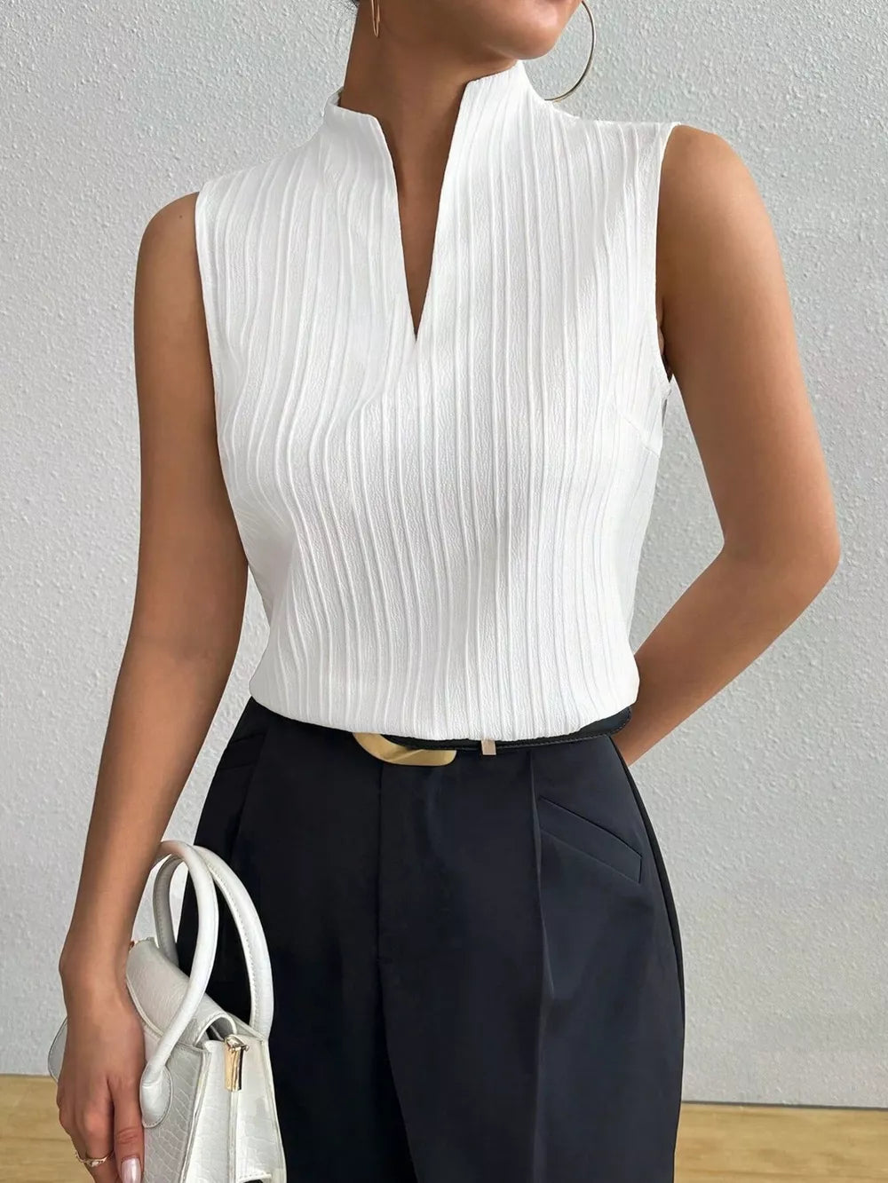 White textured sleeveless blouse with notched V-neck