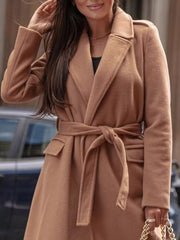 Belted longline trench coat in apricot with flap pockets and a tie waist.