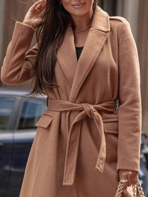 Belted longline trench coat in apricot with flap pockets and a tie waist.