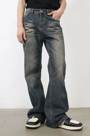 Faded wash wide-leg jeans in medium blue denim with a relaxed fit and distressed details.