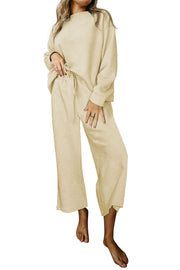 Beige loungewear set with drop sleeves and wide-leg pants featuring a textured pattern and drawstring waist.