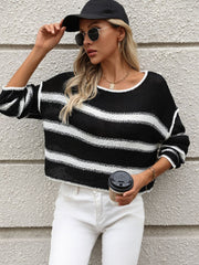 Black and white striped knit cropped sweater with a crew neck and long sleeves.