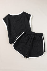 Black textured knit loungewear set with contrast trim on top and shorts.