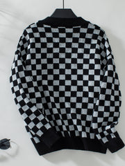 Checkerboard knit pullover sweater in black and white with a V-neck.
