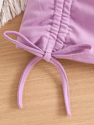 Violet toddler crop top with drawstring detail and bow.