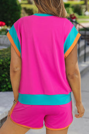 Hot pink co-ord set with turquoise and orange colorblock sleeves and hem.