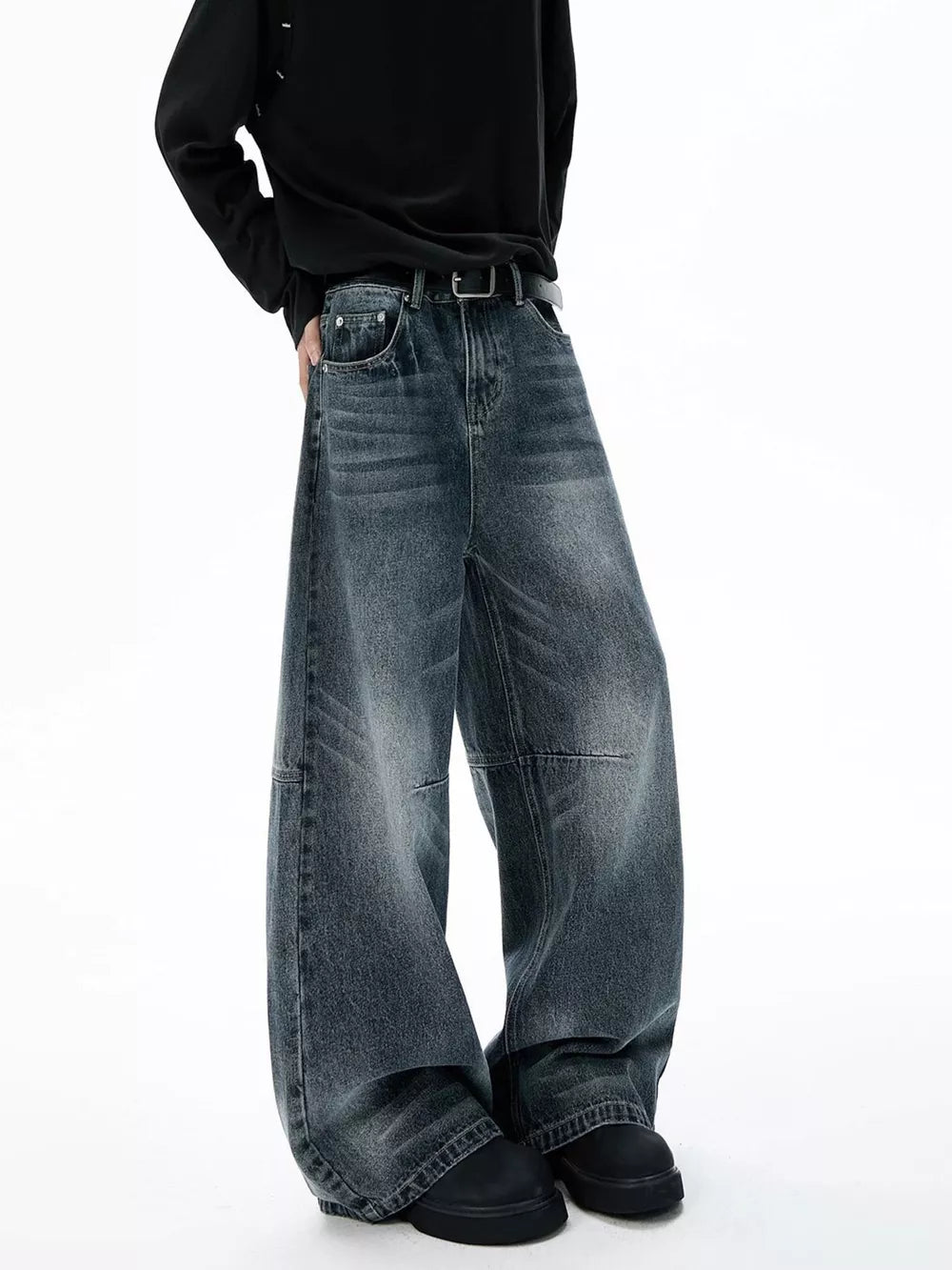 Belted dark-wash wide-leg jeans with unique paneled design and cotton fabric.