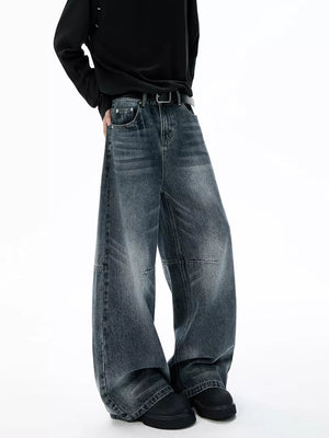 Belted dark-wash wide-leg jeans with unique paneled design and cotton fabric.