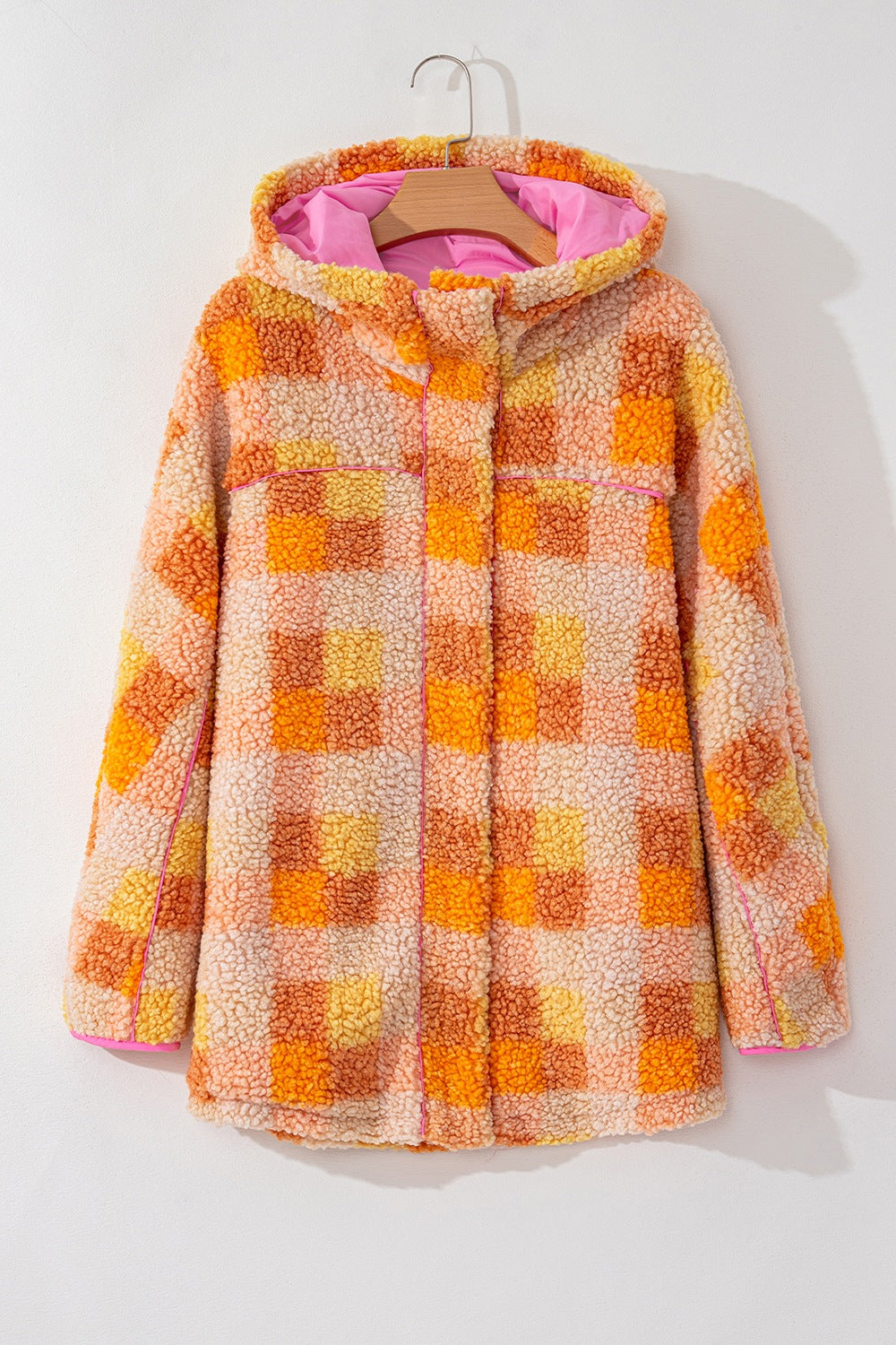 Checkerboard sherpa jacket in tangerine with contrast collar and pink hood lining.