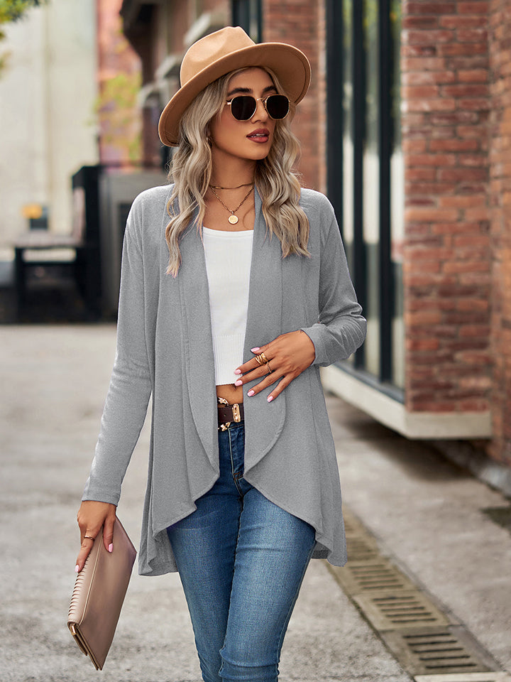 Draped cascade cardigan in cloudy blue with open front and asymmetrical hem, worn with jeans.