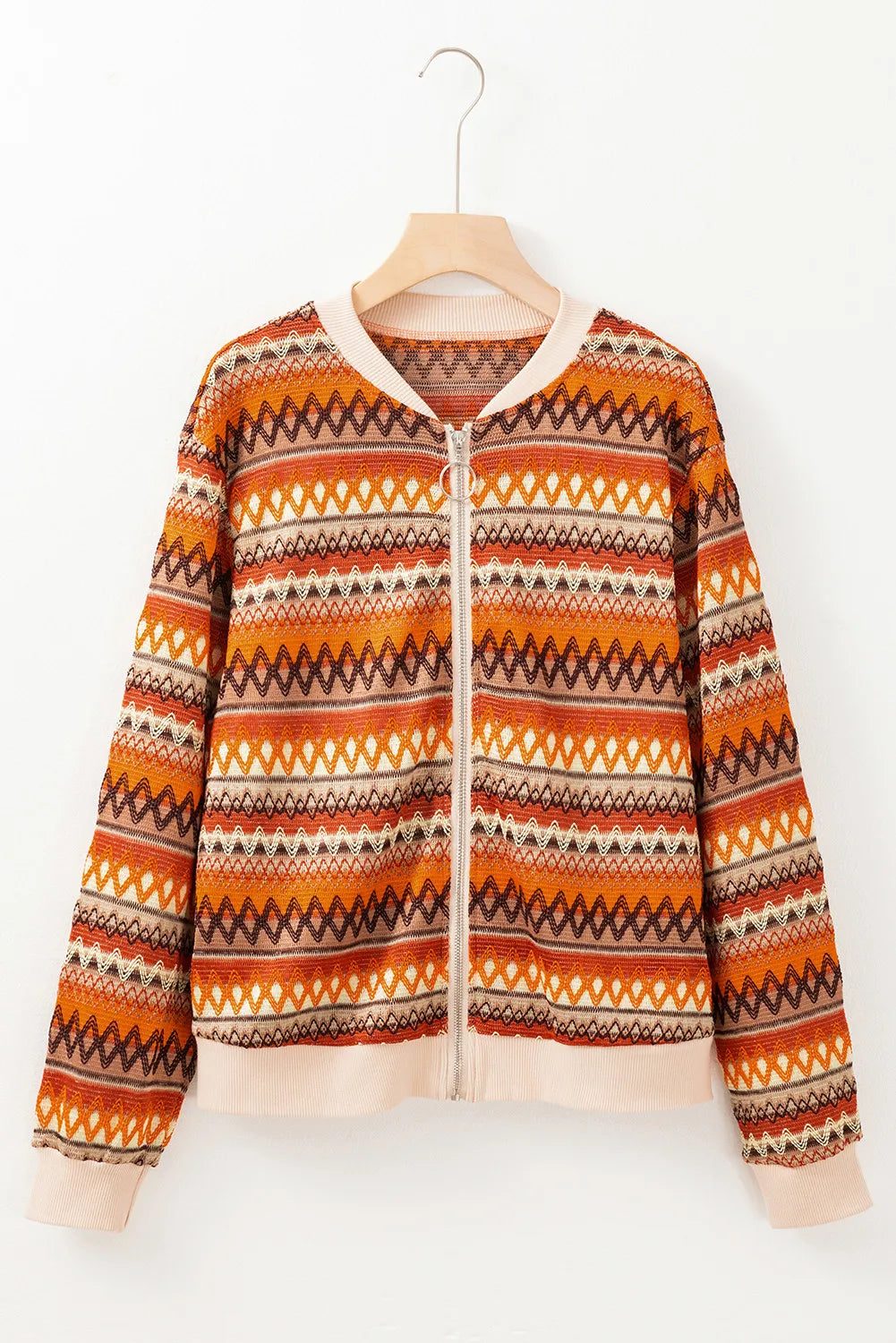 Geometric knit bomber jacket in orange with diamond pattern and zip closure.