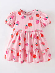 Pink tiered baby dress with puff sleeves and allover strawberry print, cotton blend.
