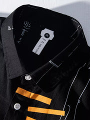 Black cotton blend long sleeve shirt with white science print and orange accents.