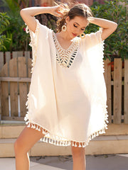 White crochet back tassel trim cover-up with V-neck and short sleeves.