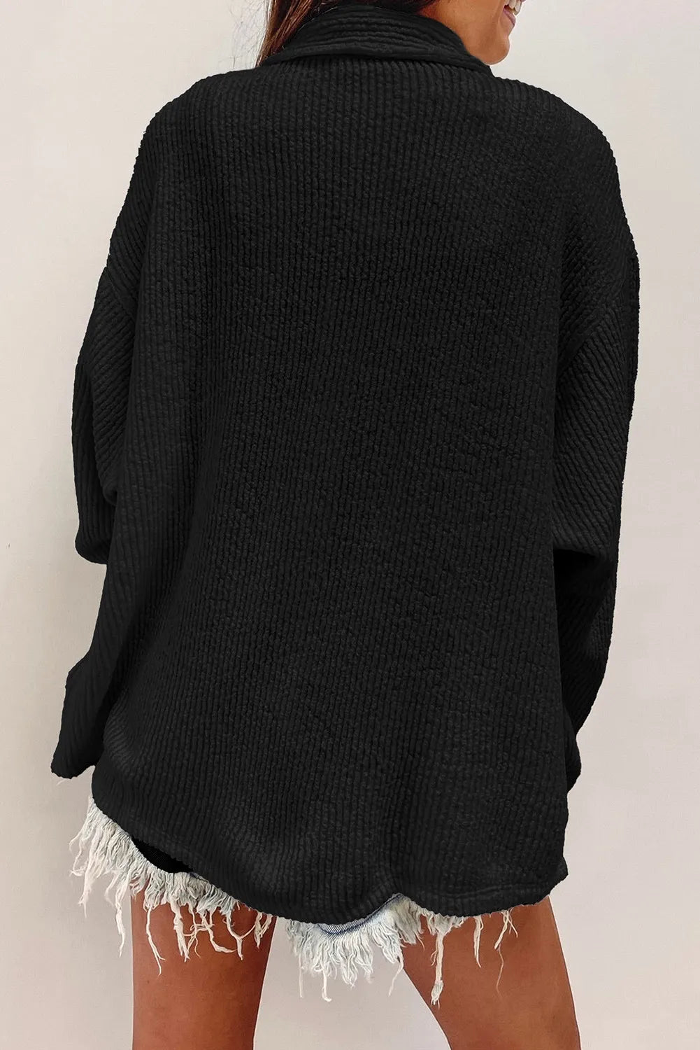 Black textured corduroy overshirt with patch pockets, shown from the back.