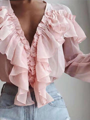 Pink chiffon blouse with cascading ruffles and plunging neckline.