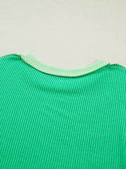 Bright green ribbed t-shirt with contrast stitching and a light green crew neck.